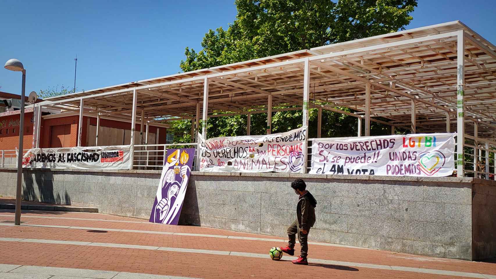Pancartas de apoyo a Unidas Podemos en la Plaza de la Constitución, en Vallecas.