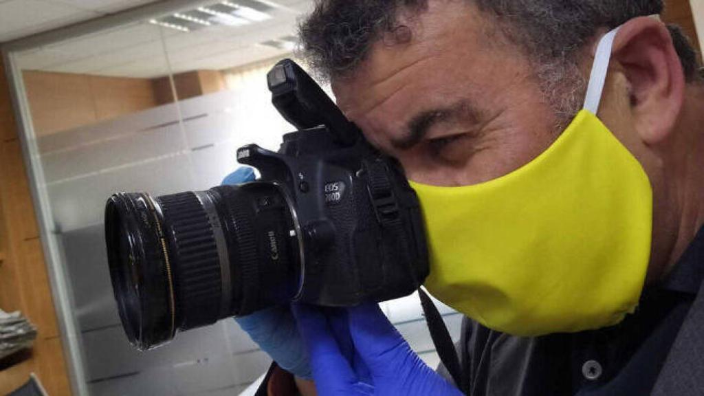 Fotógrafo con mascarilla en un acto público. Imagen de archivo