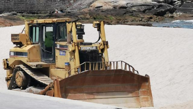 Una excavadora en la playa de Riazor.