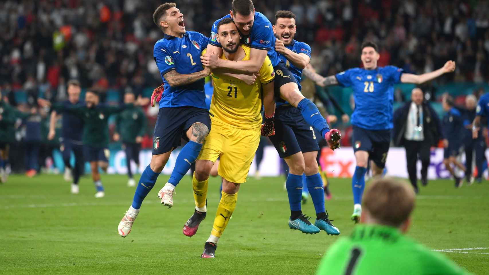 Los jugadores de Italia se abrazan a Donnarumma tras parar el penalti a Bukayo Saka