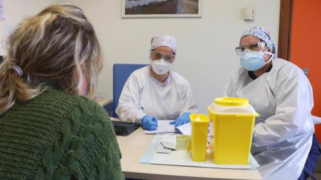 Dos sanitarias atienden a una mujer.