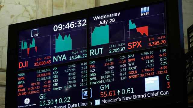A screen displays the Dow Jones Industrial Average on the floor of the New York Stock Exchange (NYSE) in New York City