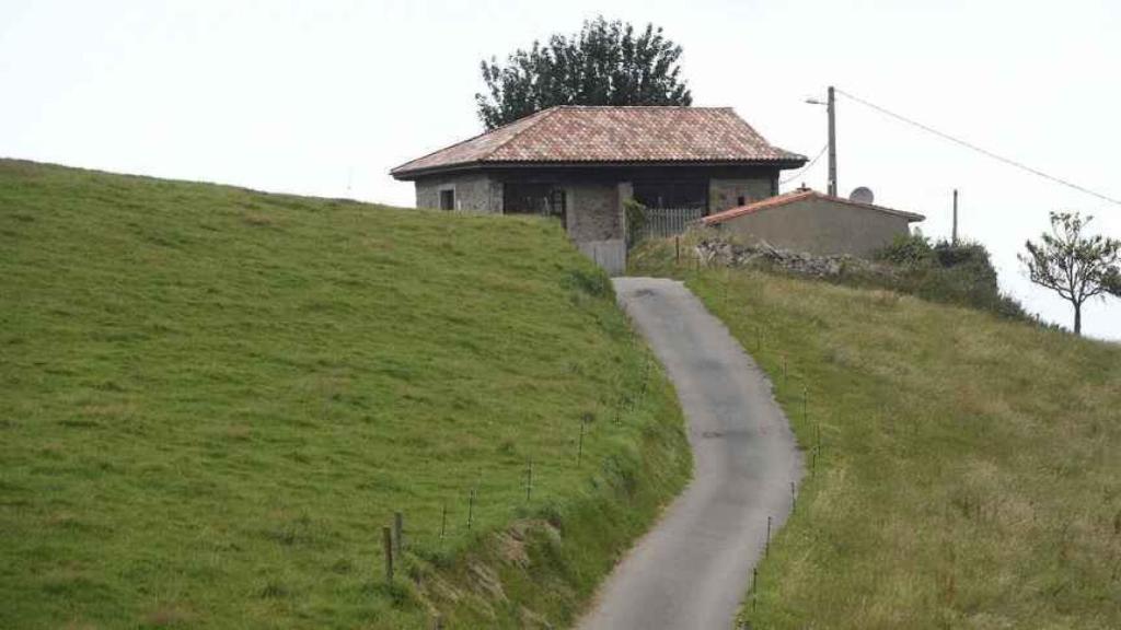 La casa de Sardéu donde vivió Menchu Álvarez del Valle, rodeada de vegetación.