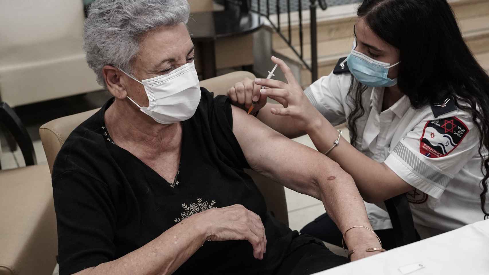 Una anciana israelí recibe la tercera dosis de la vacuna de Pfizer a comienzos de agosto. Nir Alon/EP