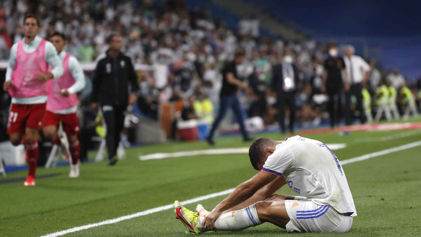 Eden Hazard, sentado sobre el césped dolorido tras un golpe