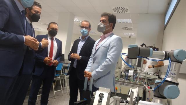 El consejero de Hacienda de Murcia (1i), este lunes, observando un modelo de robot colaborativo.