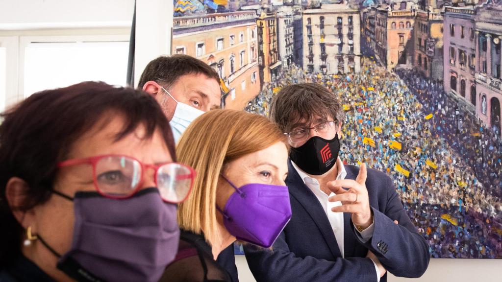 Otra imagen de la visita a Puigdemont este verano. De fondo, una foto de una manifestación proindependencia.