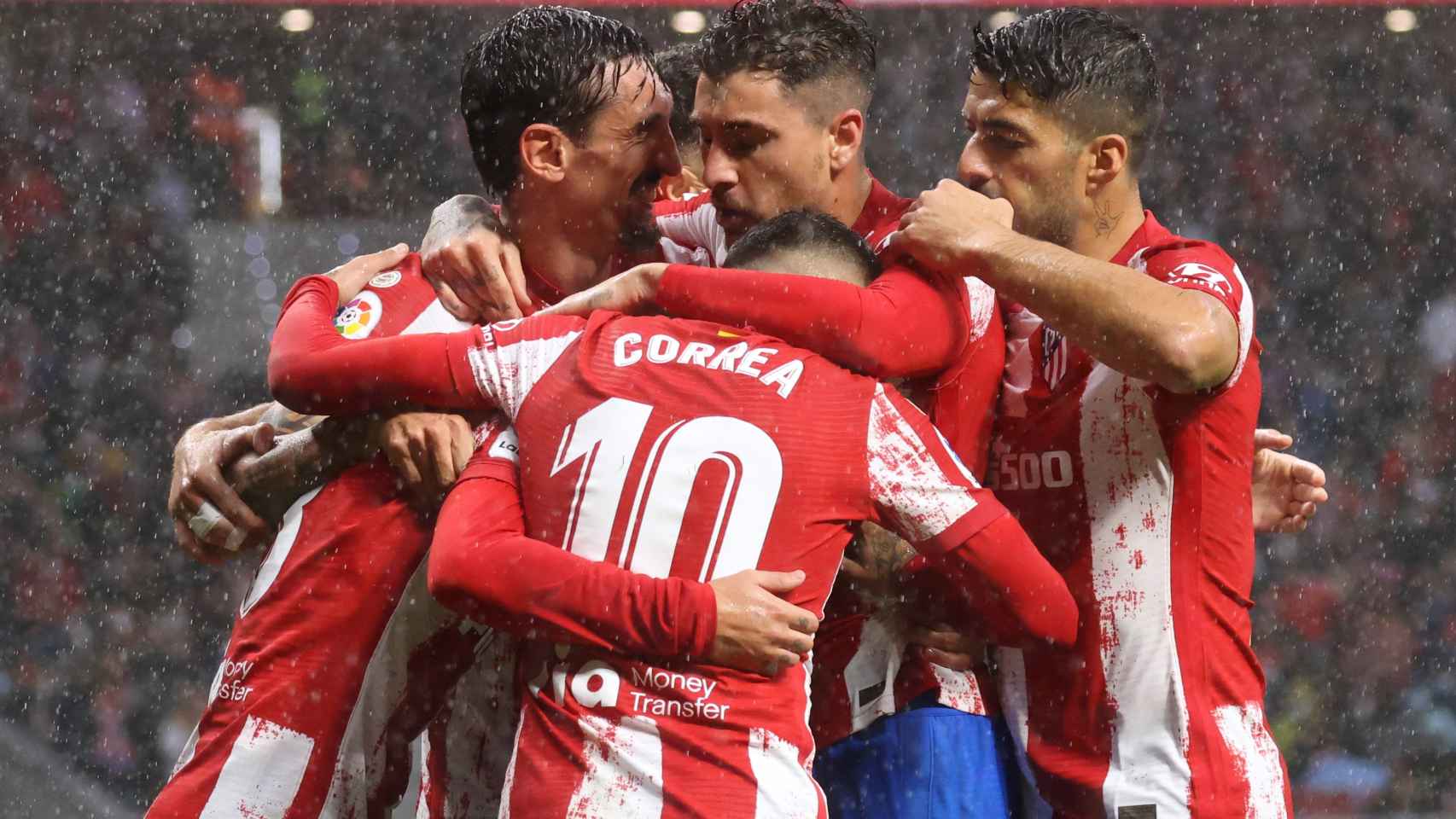 Los jugadores del Atlético celebrando un gol bajo la lluvia