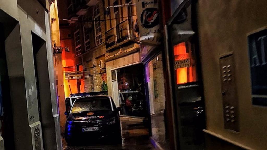 Un coche de la Policía Nacional frente a una discoteca en el centro.