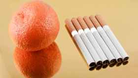 Una mandarina junto a seis cigarrillos.