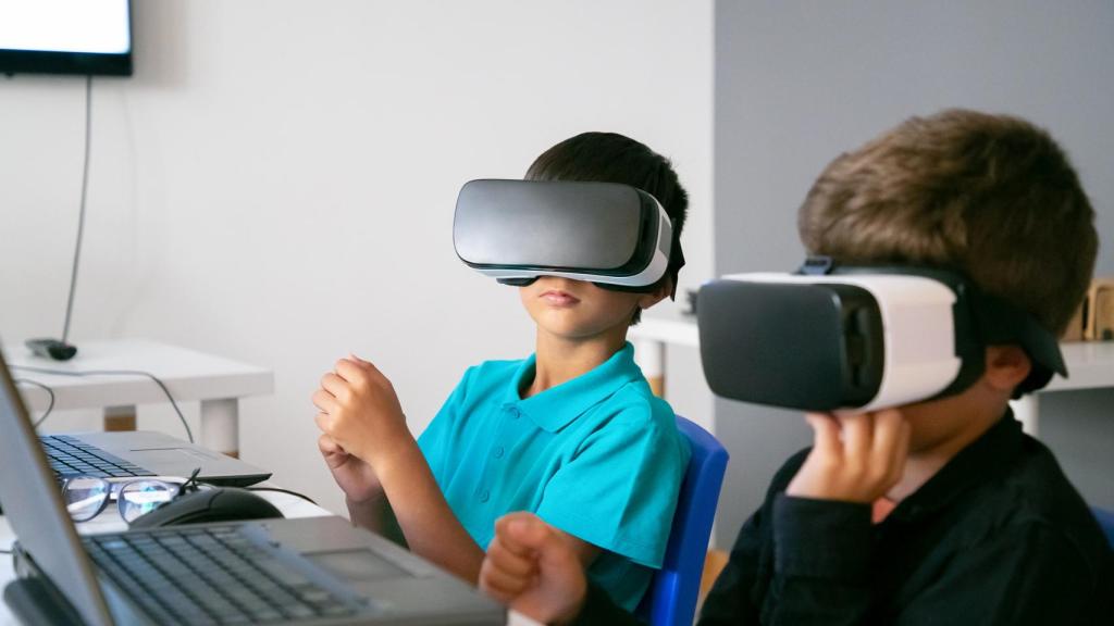 Dos niños con cascos de realidad virtual.