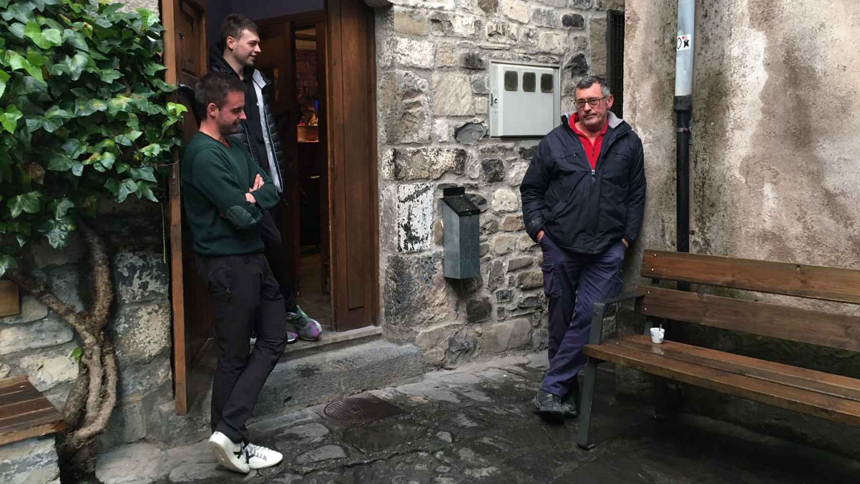 Adrián, Nicolás y Eloy, a la entrada de un bar en Hecho (Huesca).