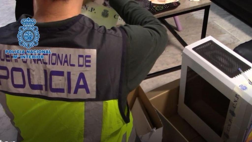 Momento en el que la Policía Nacional procede al precinto de un ordenador en la casa del detenido.