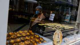 Una mujer pasa por delante de un establecimiento de pasteles de belén en Lisboa.