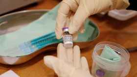 Un sanitario sostiene un vial con seis dosis de la vacuna Pfizer-BioNTech contra la Covid