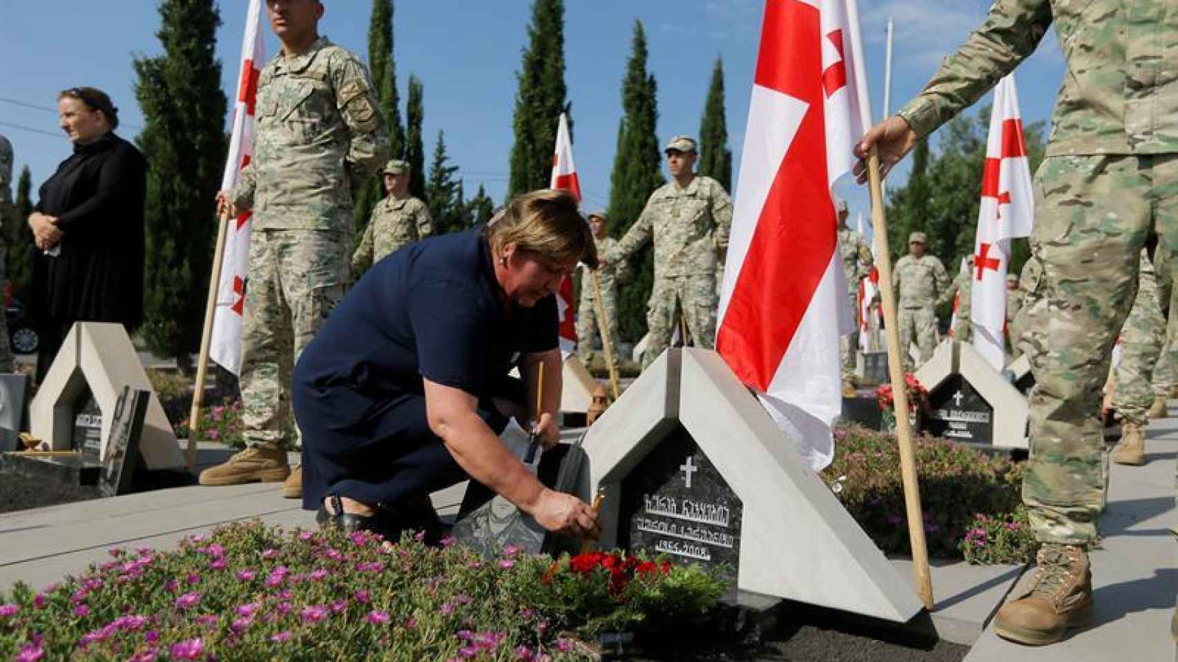 Una mujer deposita flores en la tumba de un fallecido en el conflicto de Osetia. Los enfrentamientos más sangrientos se produjeron en agosto de 2008 pero ha seguido latente hasta 10 años después.
