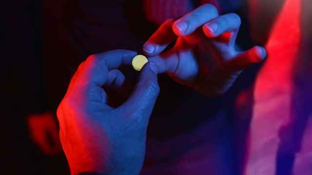 Una pareja sujeta una pastilla de MDMA.