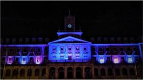 Imagen de archivo d de la fachada municipal iluminada.