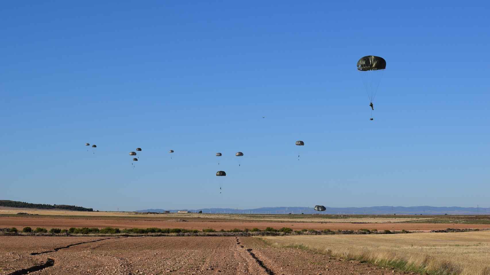 Varios paracaidistas del Ejército de Tierra a punto de tocar el suelo.