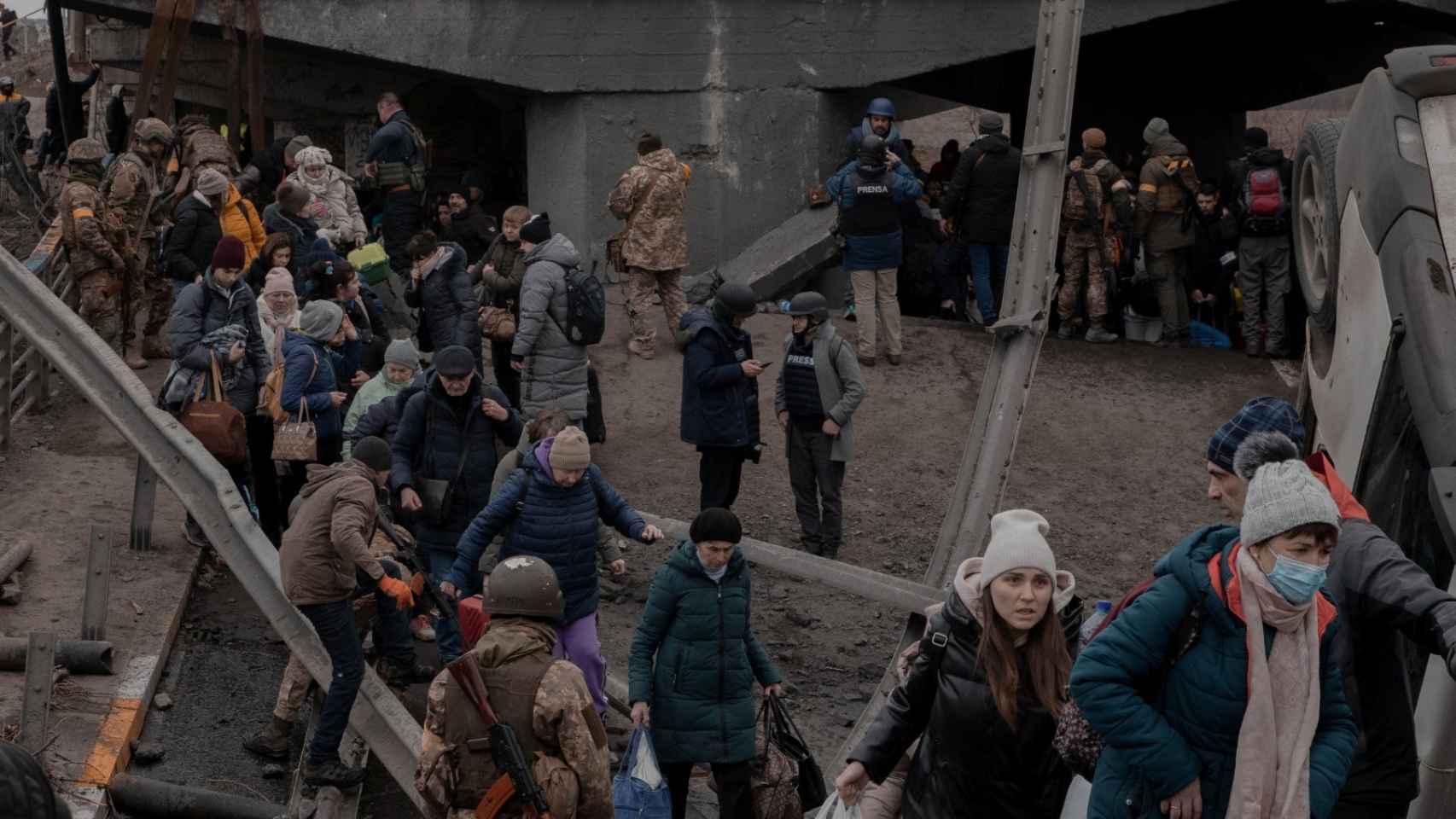 Civiles ucranianos entre escombros en Irpin.