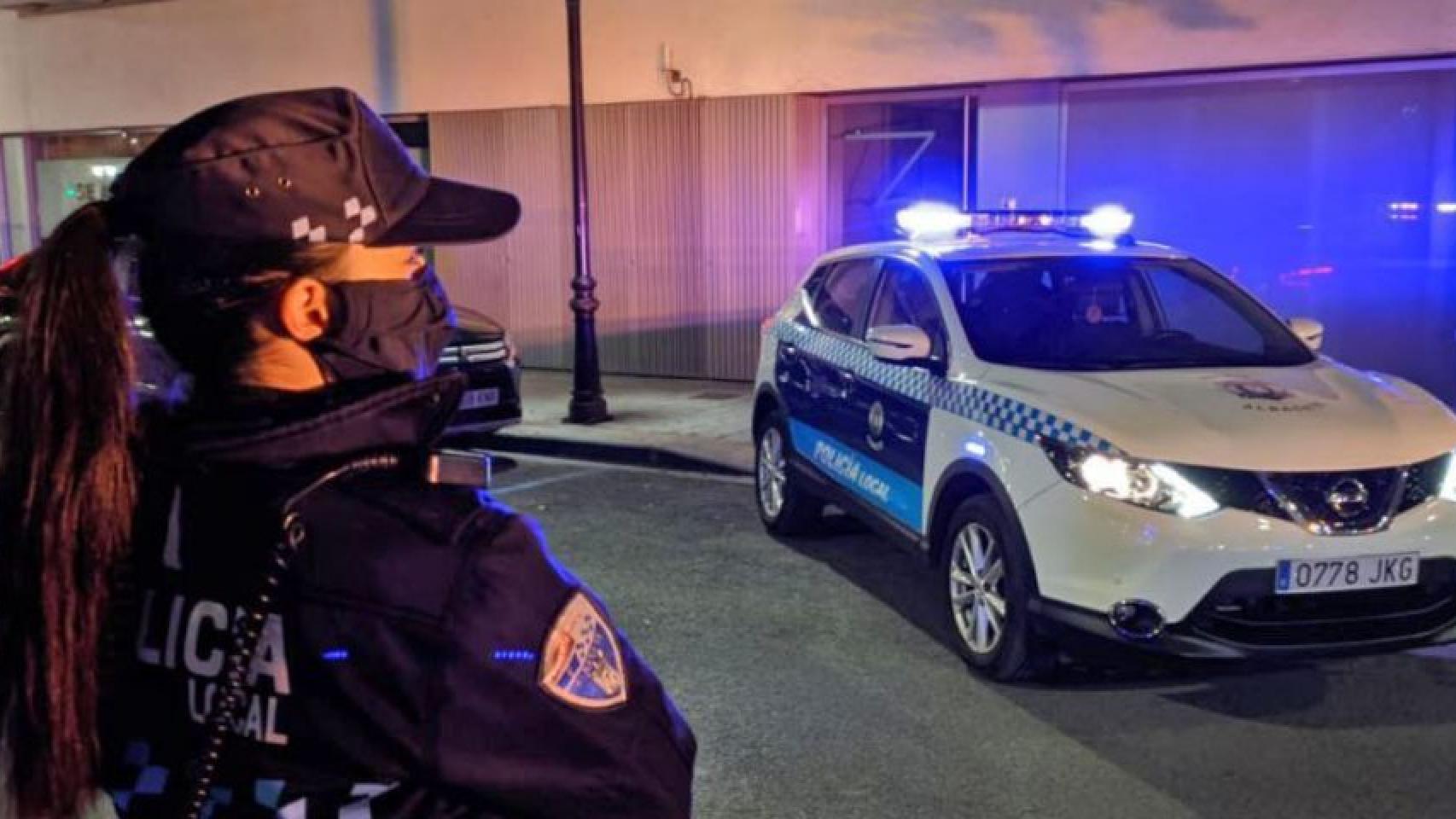 Una agente de la Policía Local de Albacete junto a un coche patrulla.