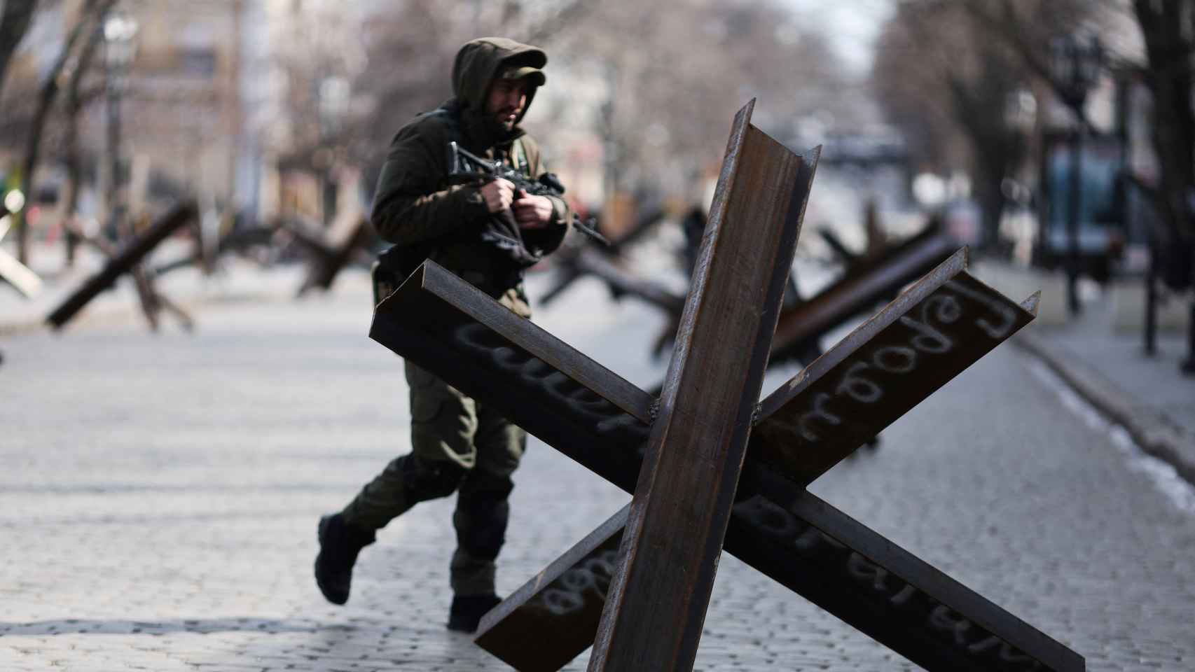 Un soldado ucraniano pasa entre las barricadas levantadas para defenderse de la invasión rusa.
