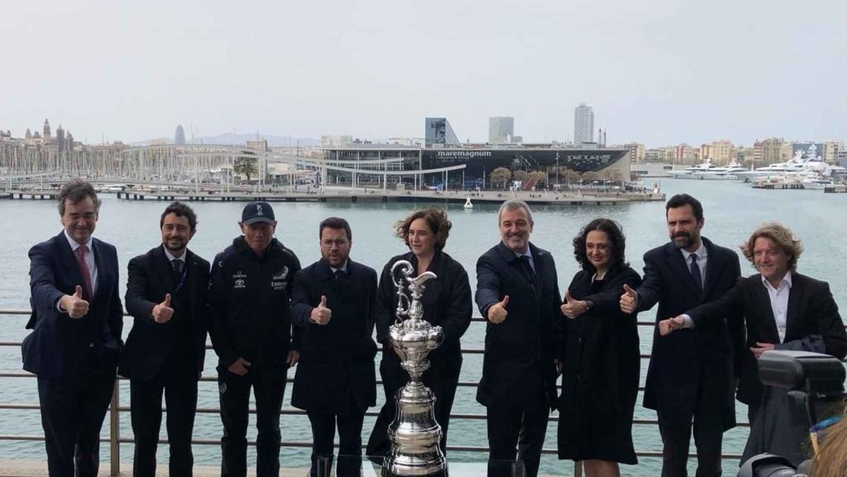 Pere Aragonès,  Ada Colau y otros representantes políticos junto con el trofeo de la Copa América de vela