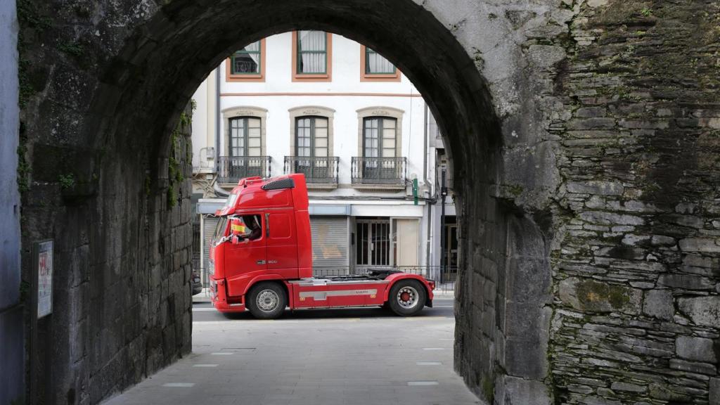 Un camión pasa bajo la Puerta de Santiago de la Muralla Romana de Lugo.