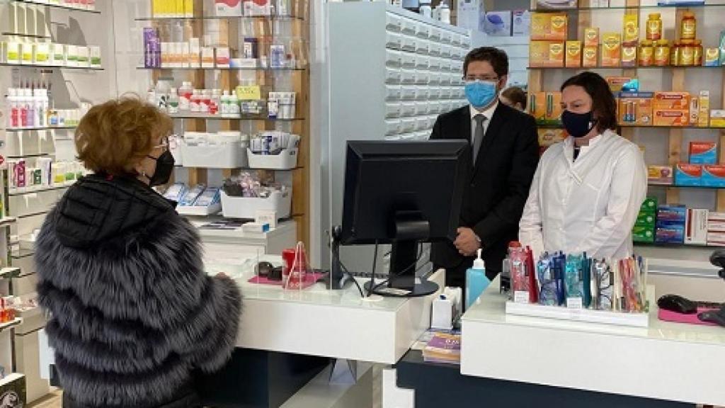 Una mujer retira sus medicamentos en un farmacia mediante su receta electrónica concertada.