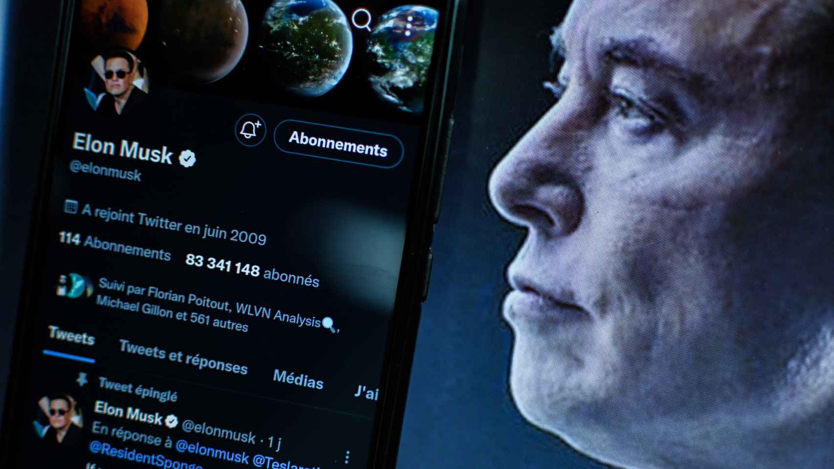 Vista del rostro de Elon Musk frente a un ordenador con un pantallazo de Twitter