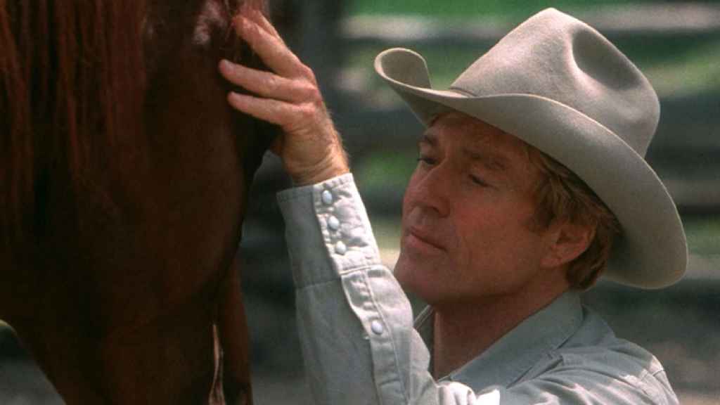 Nicholas Evans. A la derecha, Robert Redford en la películas 'El hombre que susurraba a los caballos'