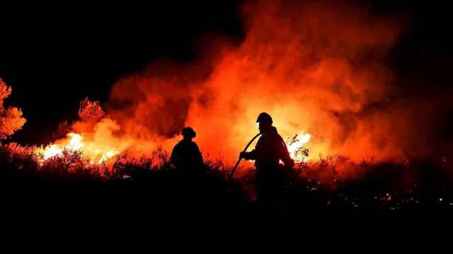 Dos bomberos trabajando en las tareas de extinción del incendio de la Vall d'Ebo de 2022.