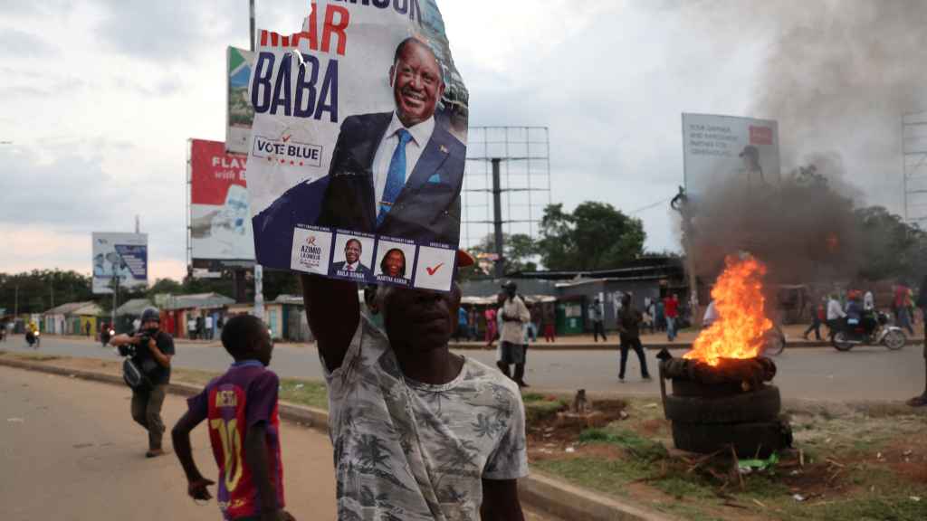 Un manifestante sostiene un cartel de Raila Odinga, líder de la oposición, mientras estallan las protestas en Kenia.