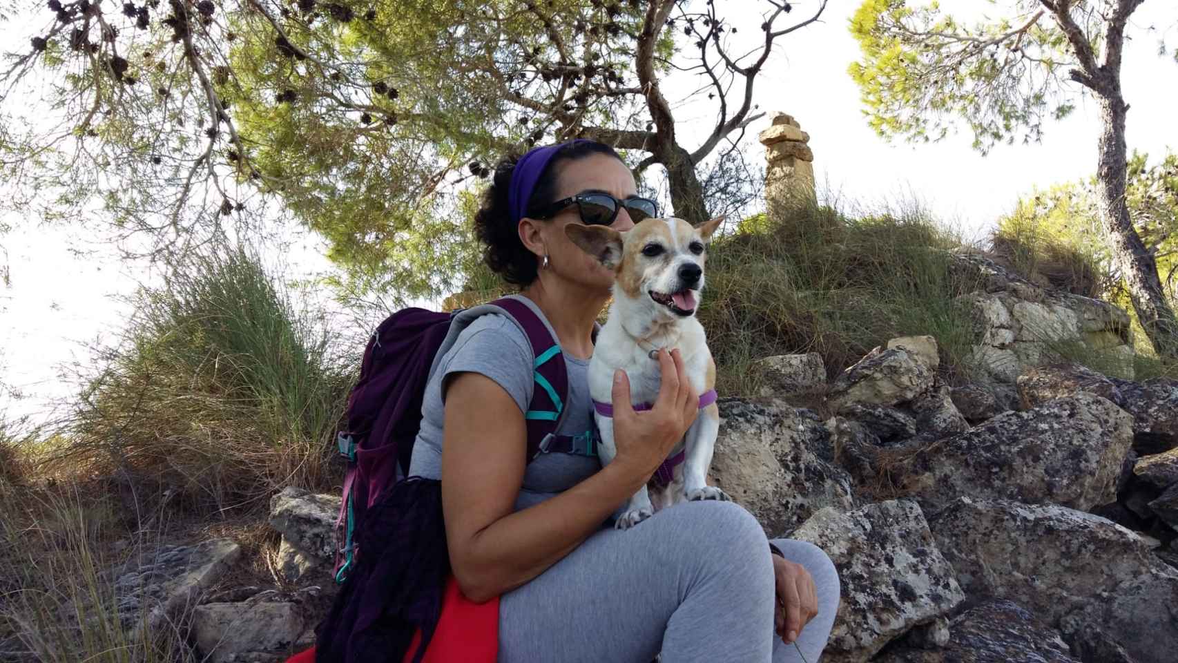 María Martínez, auxiliar de enfermería, junto a su perrita Lola, en una ruta senderista.