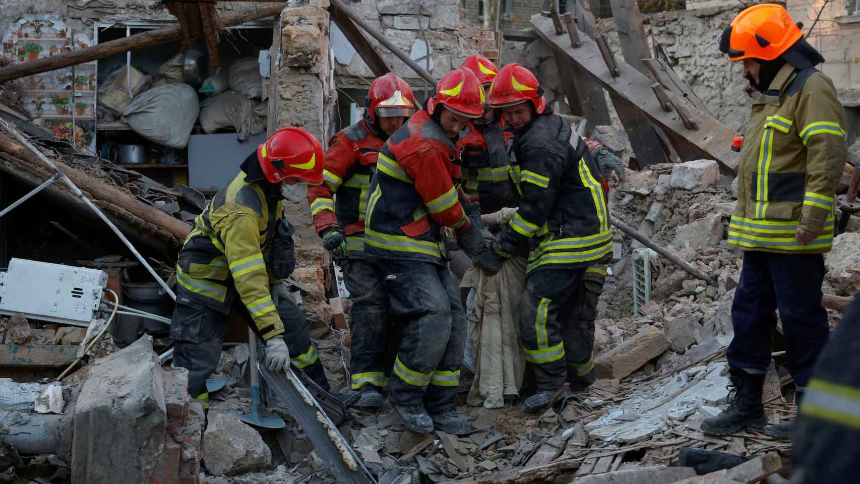 Servicios de emergencia ucranianos retiran escombros tras el ataque ruso.