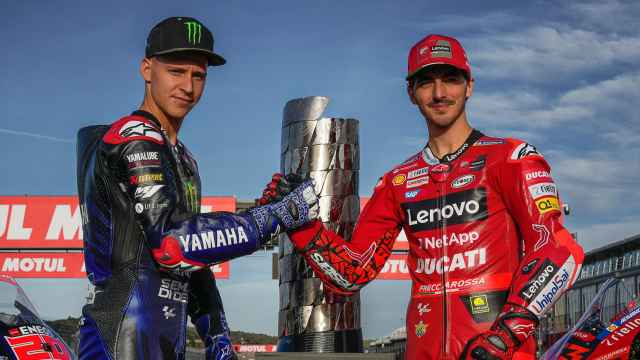 Fabio Quartararo, a la izquierda, y Pecco Bagnaia posan delante de la Torre de los Campeones de MotoGP.