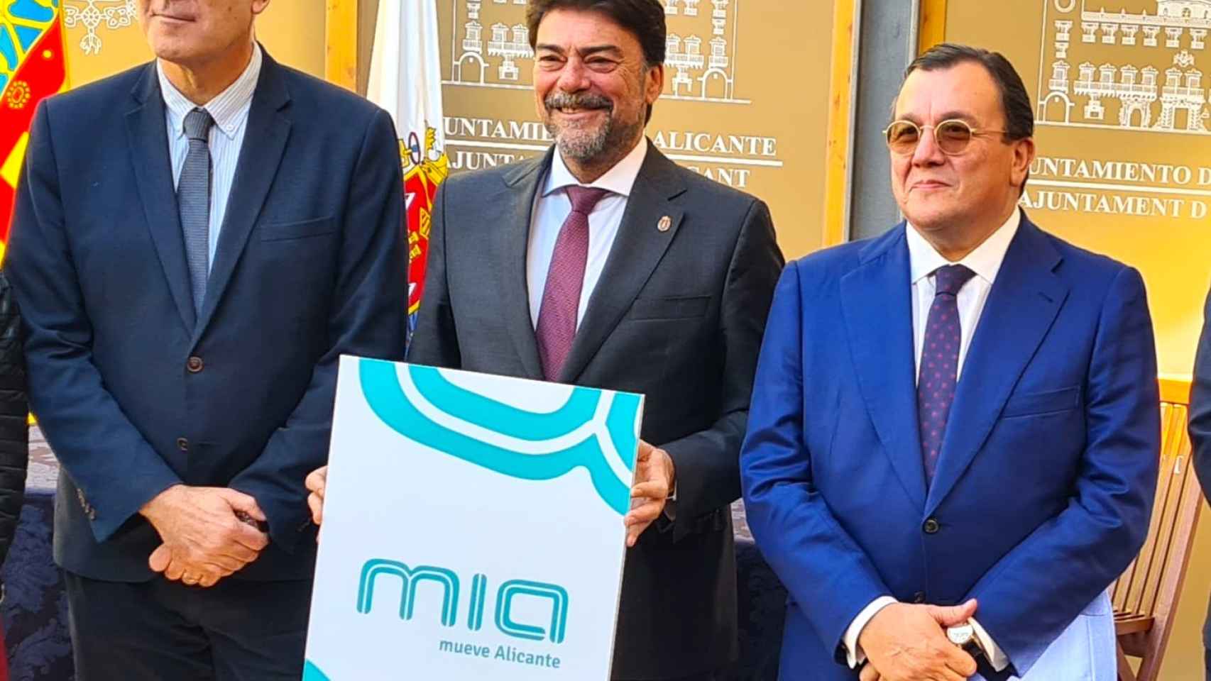 Luis Barcala, con Antonio Arias, sostiene el nuevo logotipo de MIA.