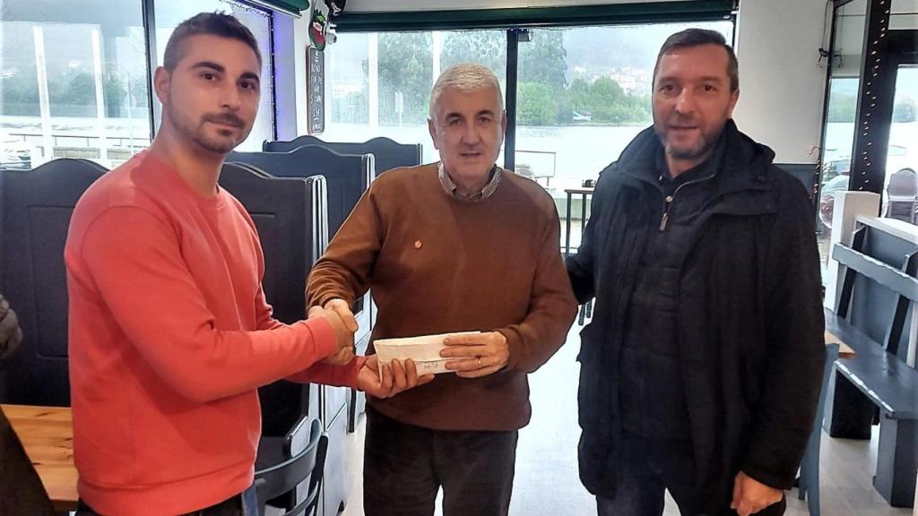 Miembros de la asociación haciendo entrega de la donación a Cáritas Noia