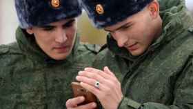 Soldados rusos con un teléfono móvil en la mano