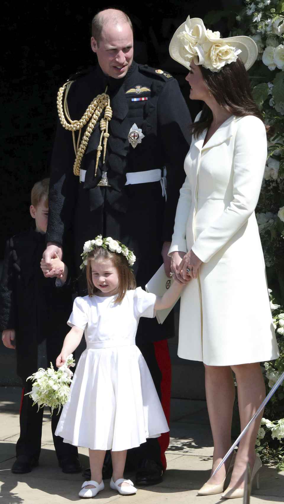 Los Príncipes de Gales con su hija, en la boda de Harry.