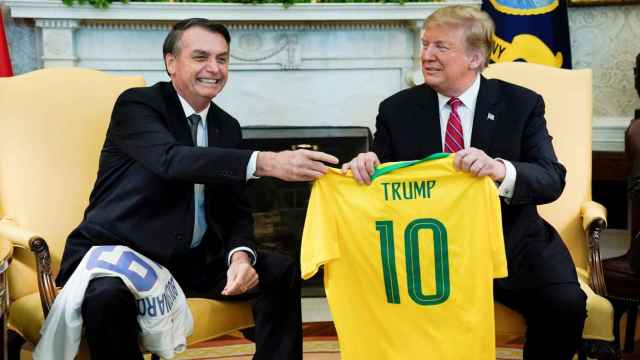 Jair Bolsonaro, expresidente de Brasil, entregando la camiseta de la selección de fútbol a Donald Trump en 2019.