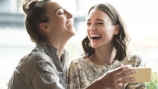 Dos mujeres, sonriendo.