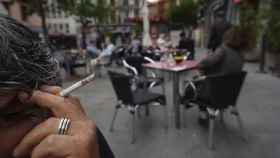 Imagen de archivo de un hombre fumando en una terraza, cuando estaba permitido.