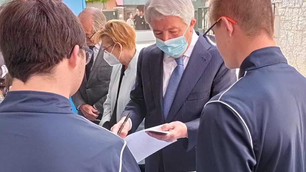 El presidente del Atlético, Enrique Cerezo, con dos menores de otra escuela con discapacidad en imagen de archivo.