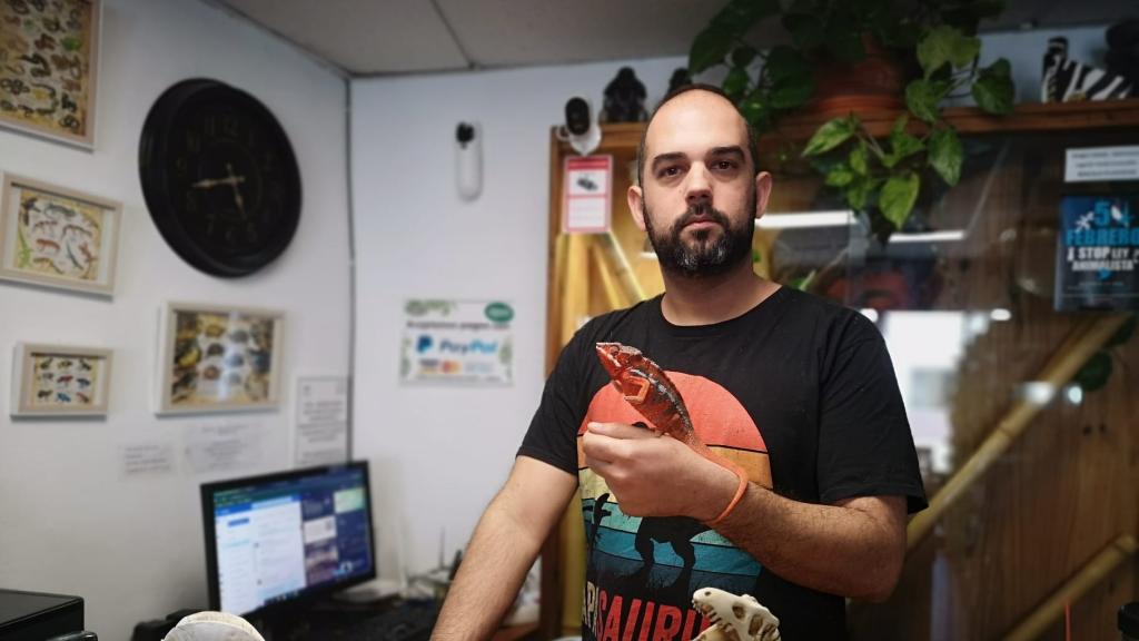 Alberto Gallardo, con una iguana, en su tienda de animales exóticos de Chiclana de la Frontera (Cádiz).