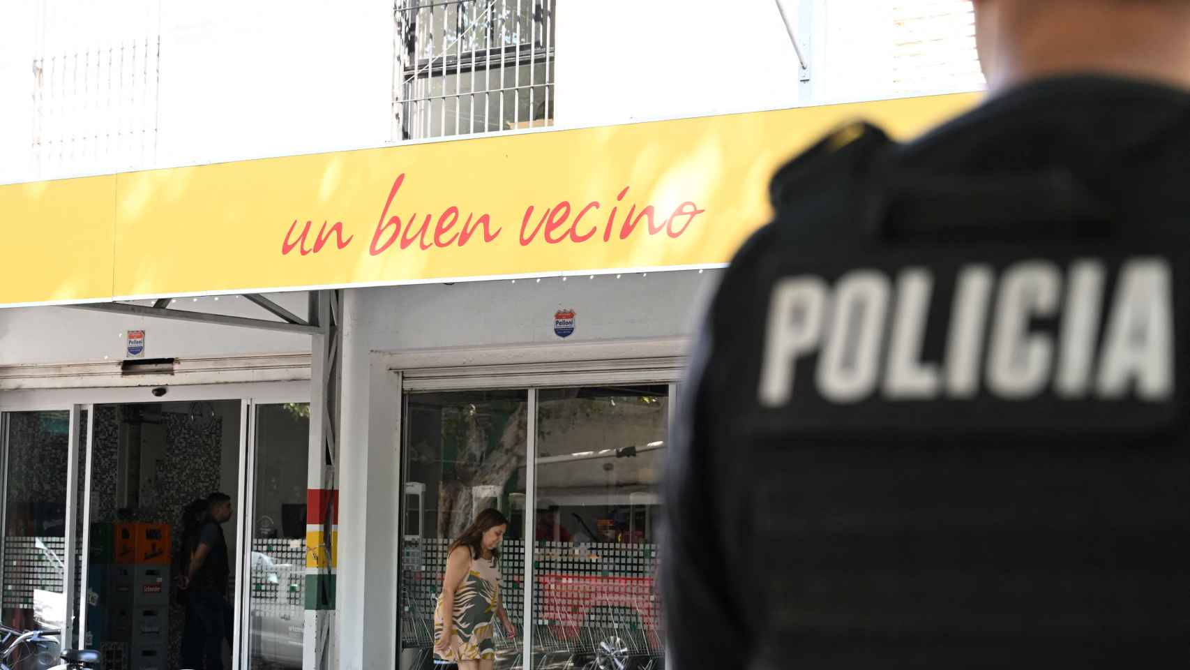 Un agente de policía custodia el supermercado de la familia de Antonela Roccuzzo, esposa de Messi, después del tiroteo.