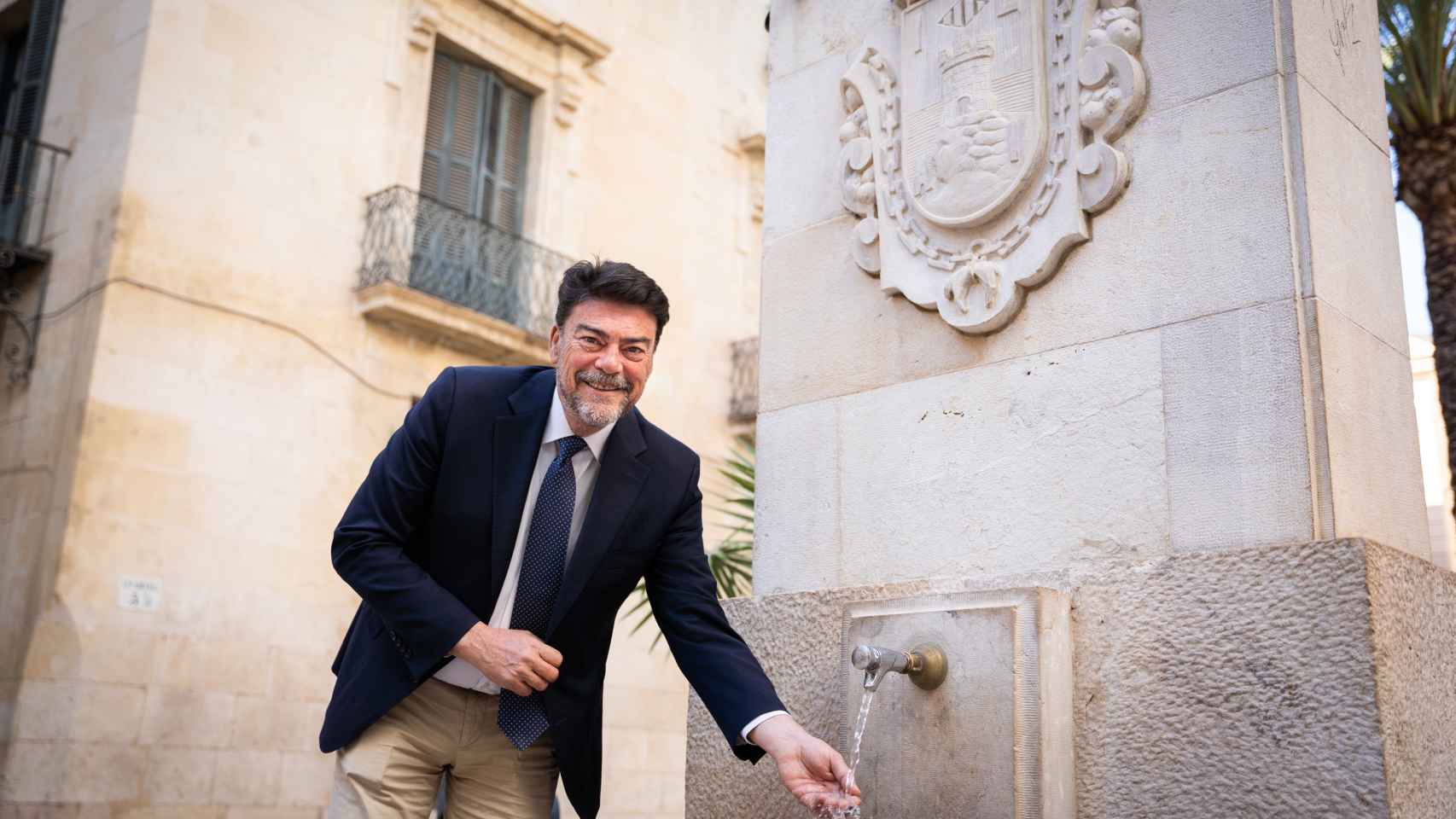 El alcalde de Alicante, Luis Barcala, posa en una de las primeras fuentes de agua potable del municipio, situada justo detrás del ayuntamiento.