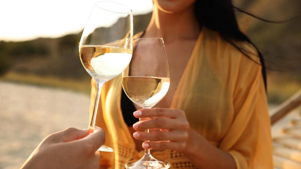 Imagen de archivo de una pareja brindando con copas de vino.