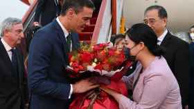 El presidente del Gobierno, Pedro Sánchez, recibe un ramo de flores a su llegada al aeropuerto internacional de Pekín (China), el jueves 30 de marzo.