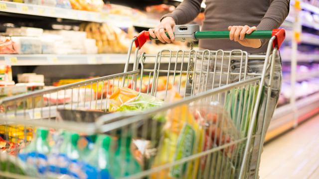 Detalle de una persona comprando en el supermercado.